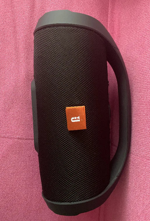 Black boombox speaker with a handle.