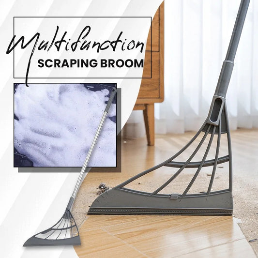 Image of a long gray scraping broom with silicone end, scraping up debris from a hardwood floor.