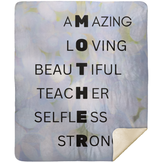 Rectangular blanket with blue peonies background and MOTHER acrostic poem down the middle. Right bottom corner upturned to display sherpa lining/