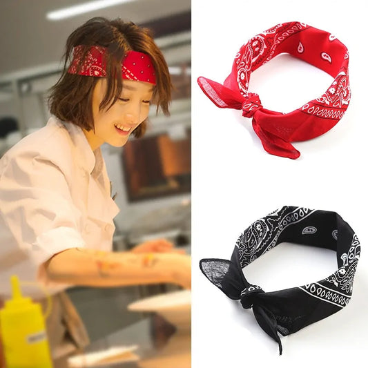 Woman working in professional kitchen wearing a chef coat and red bandana. Picture also shows bandanas in red and black.