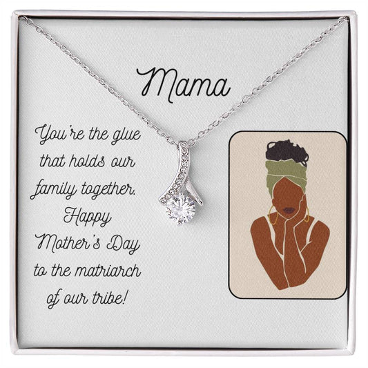 White message card for Mama. Happy Mother's Day!  Drawing of a brown woman wearing a green head scarf. Silver necklace with cubic zirconia pendant.