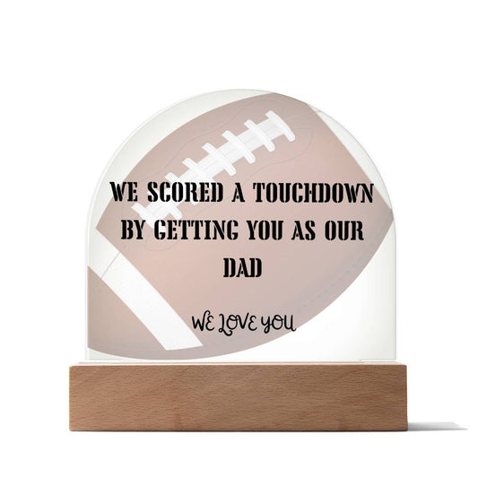 Dome-shaped plaque with football background. Touchdown dad message. In wooden base.