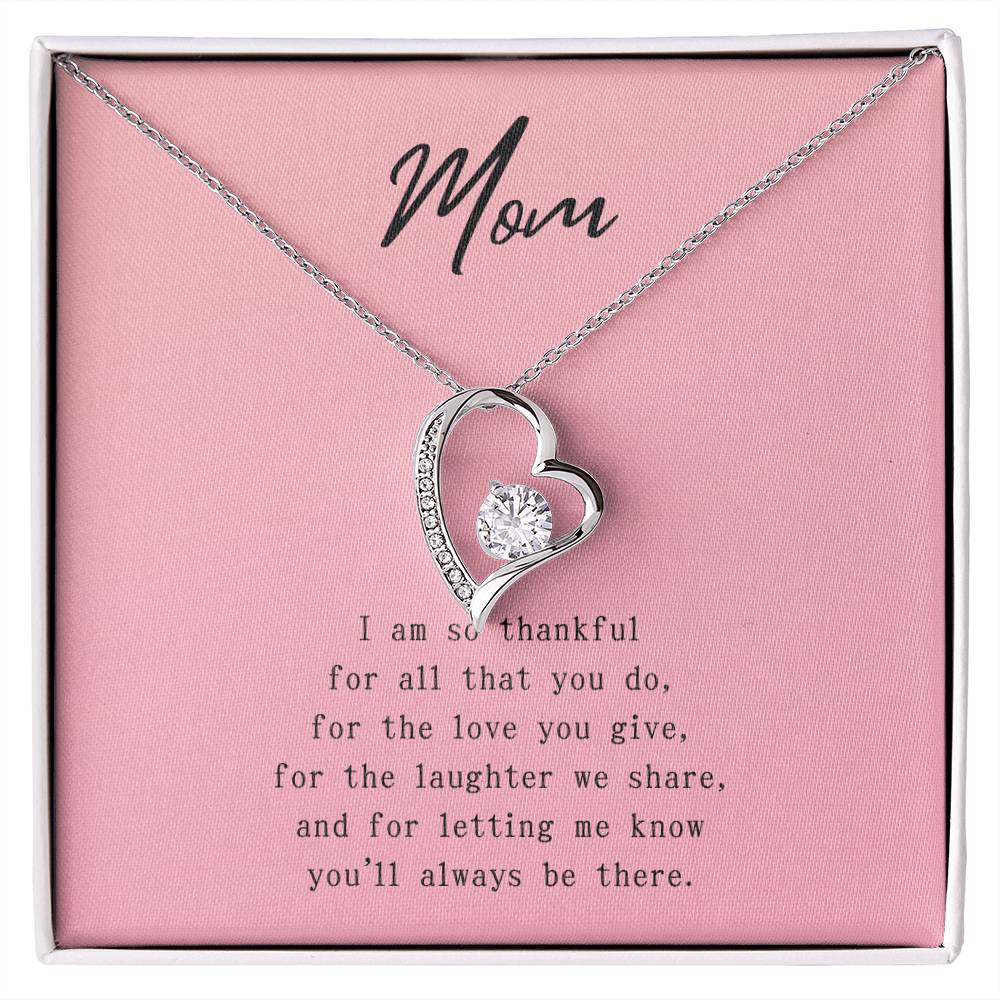 Pink message card with poem to Mom. Silver necklace with cubic zirconia heart-shaped pendant.