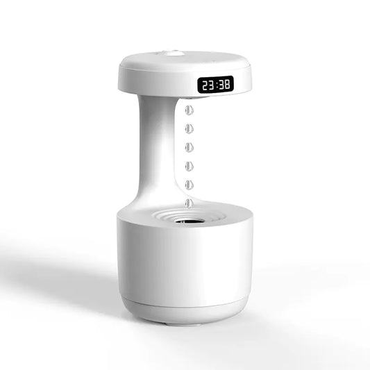 White table top machine with timer at the top and water dripping into a canister at the bottom.